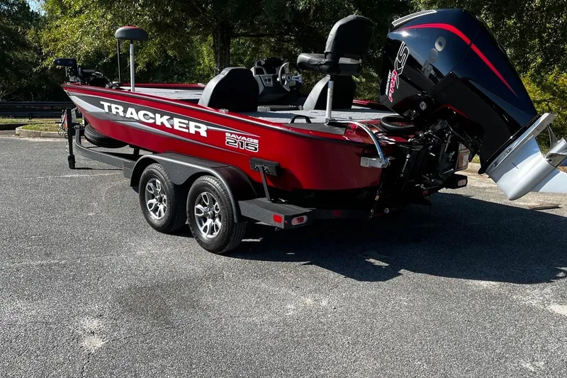 Slide: The Image of 2025 Tracker Savage 215 boat with dual-axle trailer, parked outdoors. - 5
