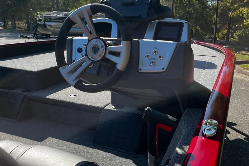 Slide: The Image of Steering wheel and dashboard of 2025 Tracker Savage 215 boat in sunlight. - 7
