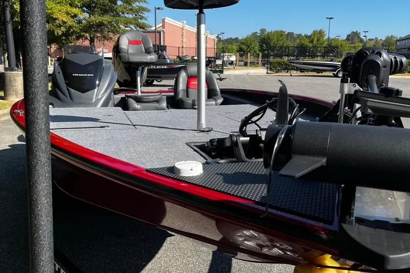 Slide: The Image of 2025 Tracker Savage 215 boat with sleek design and modern features, parked outdoors. - 8