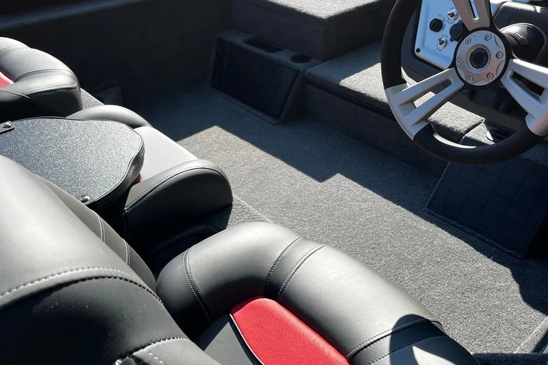 Slide: The Image of 2025 Tracker Savage 215 boat interior with steering wheel and leather seats. - 9