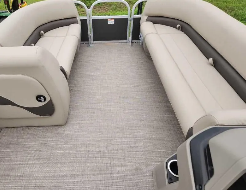 Slide: The Image of 2025 Sun Tracker Party Barge 18 DLX interior with beige seating and spacious layout. - 49