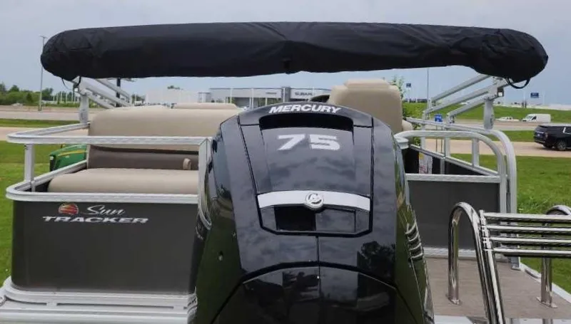 Slide: The Image of 2025 Sun Tracker Party Barge 18 DLX with Mercury 75 engine, parked outdoors. - 6