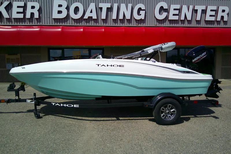 Slide: The Image of 2025 Tahoe T16 boat on trailer outside a boating center. - 0