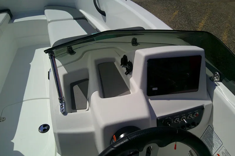 Slide: The Image of 2025 Tahoe T16 boat dashboard with steering wheel and control panel. - 10