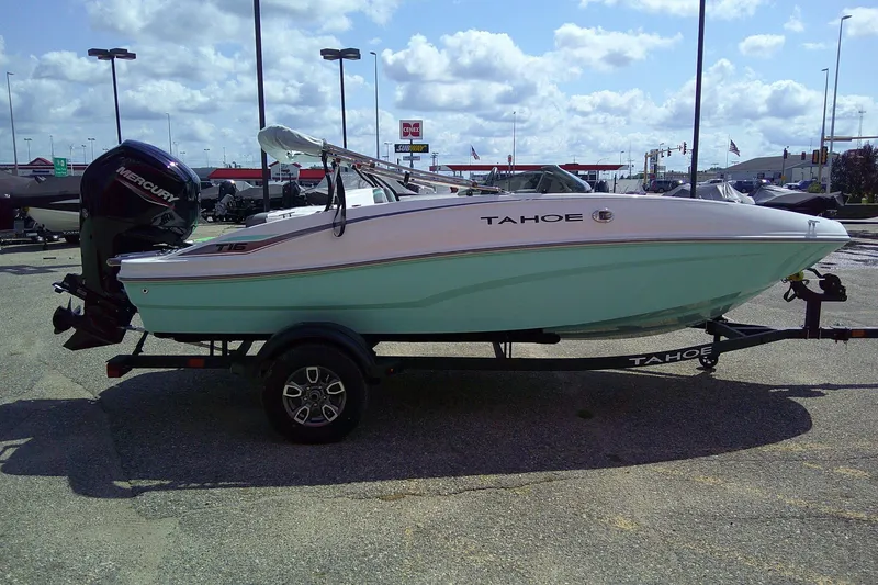 Slide: The Image of 2025 Tahoe T16 boat on trailer, parked outdoors under a cloudy sky. - 4