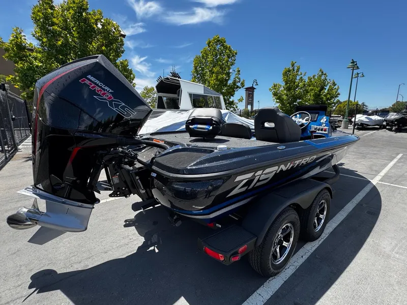 Slide: The Image of 2025 Nitro Z19 Pro boat with Mercury Pro XS engine in parking lot. - 2