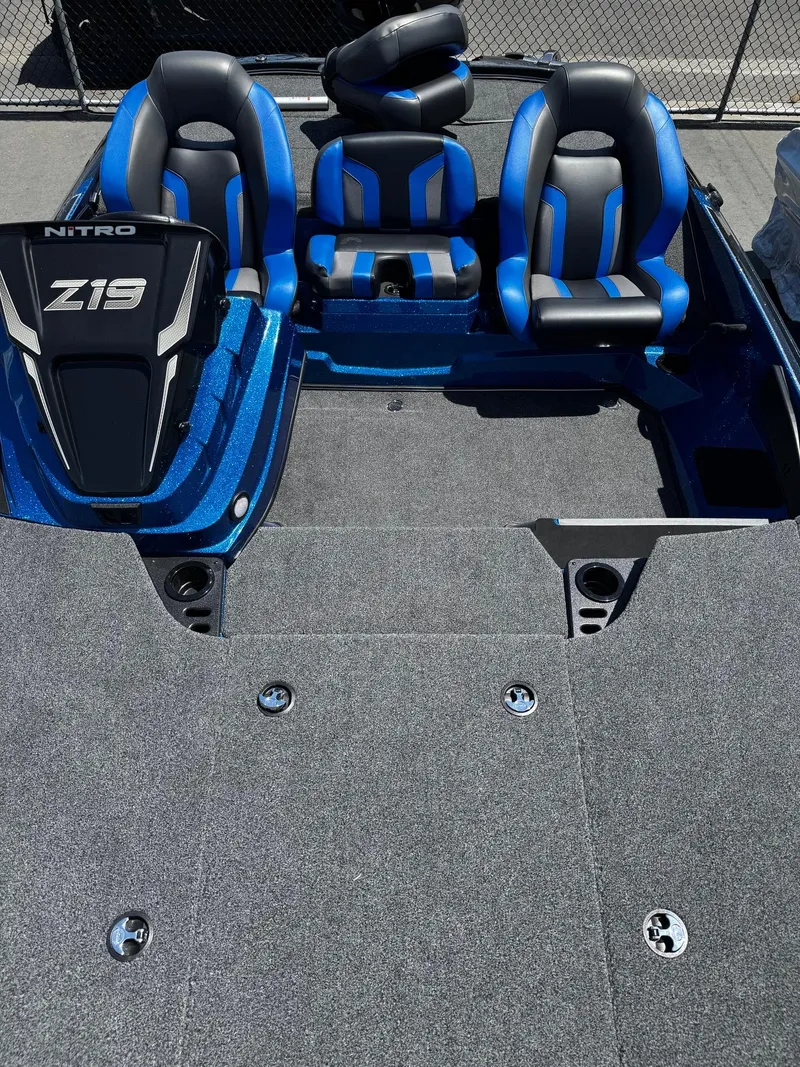 Slide: The Image of 2025 Nitro Z19 Pro boat interior with blue and black seating, spacious deck. - 5