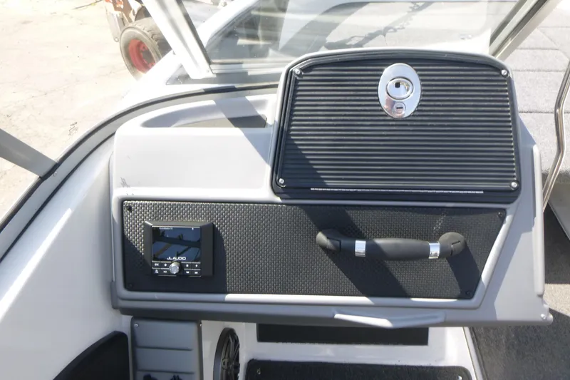 Slide: The Image of 2024 Ranger 1850MS boat dashboard with JL Audio system and storage compartment. - 10