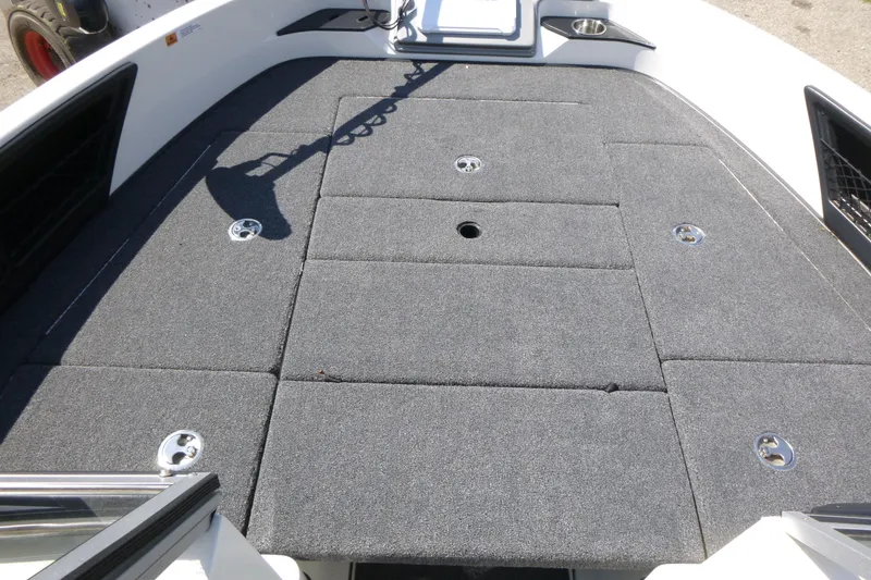 Slide: The Image of 2024 Ranger 1850MS boat deck with gray carpet and storage compartments. - 11