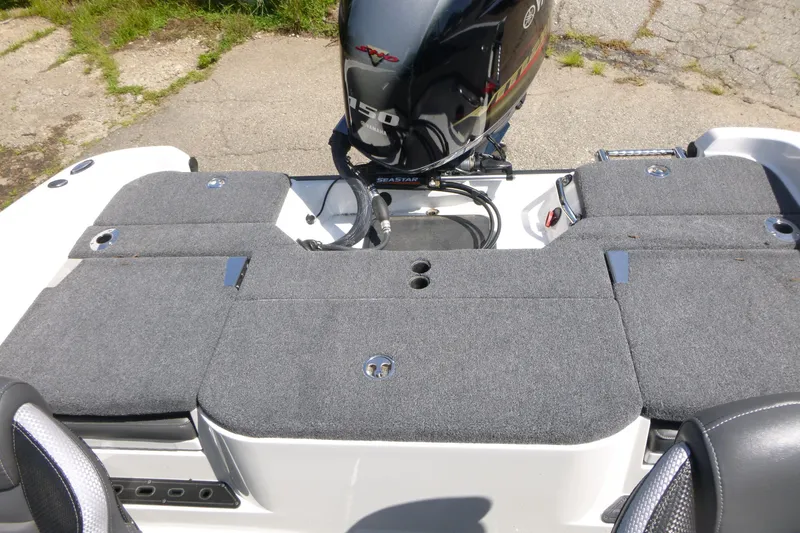 Slide: The Image of 2024 Ranger 1850MS boat with Yamaha 150 engine, featuring a spacious carpeted deck. - 18