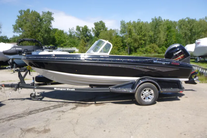 Slide: The Image of 2024 Ranger 1850MS boat on trailer, black and white design, parked outdoors. - 3