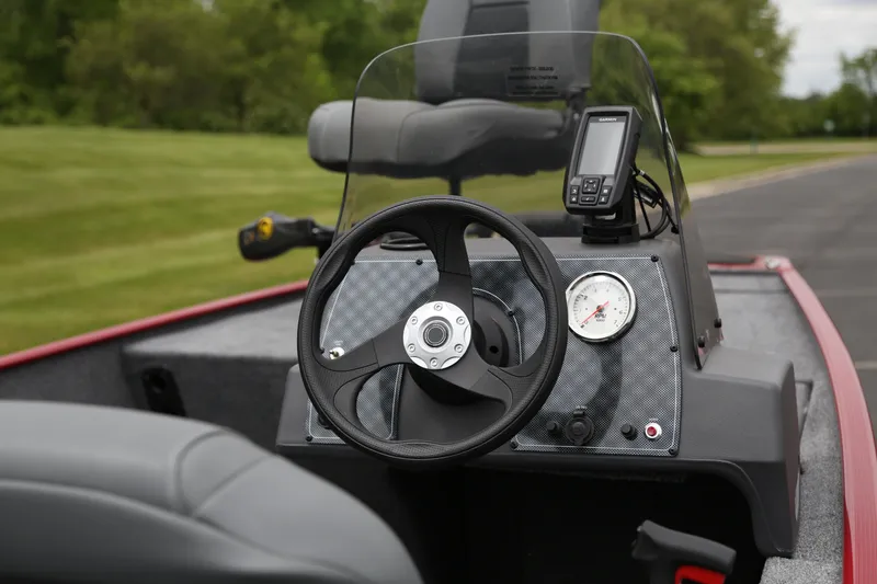 Slide: The Image of 2025 Tracker Bass Tracker Classic XL boat dashboard with steering wheel and gauges. - 6