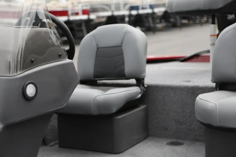 Slide: The Image of 2025 Tracker Bass Tracker Classic XL boat interior with gray seating and steering console. - 7