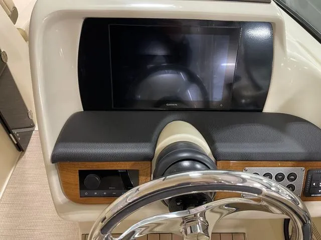 Slide: The Image of 2023 Chris-Craft Calypso 24 dashboard with steering wheel and Garmin display. - 11