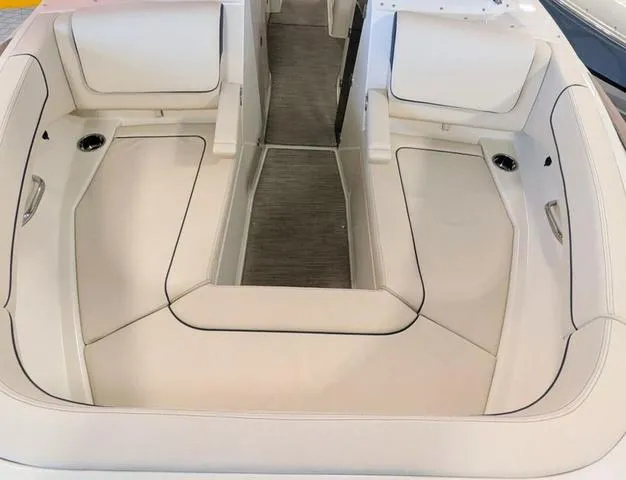 Slide: The Image of 2023 Chris-Craft Calypso 24 boat interior with white cushioned seating and sleek design. - 13