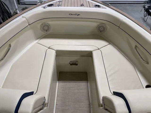 Slide: The Image of 2023 Chris-Craft Calypso 24 boat interior with cream seating and wood accents. - 14