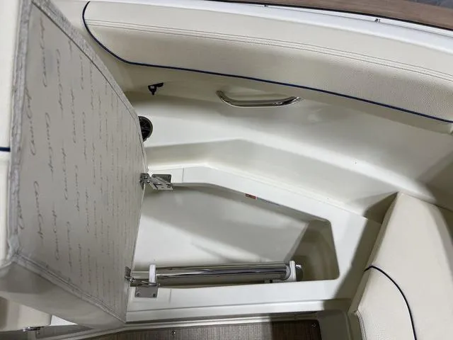 Slide: The Image of 2023 Chris-Craft Calypso 24 interior seating with storage compartment. - 19