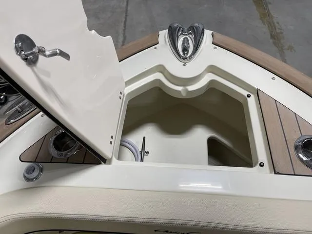 Slide: The Image of 2023 Chris-Craft Calypso 24 boat storage compartment with open hatch, showcasing interior details. - 22