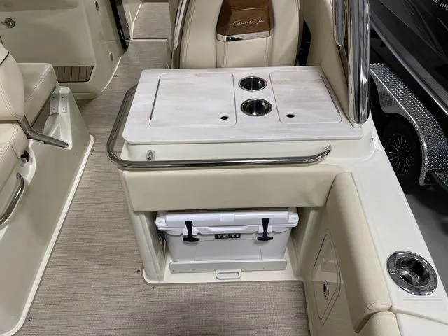 Slide: The Image of 2023 Chris-Craft Calypso 24 interior with Yeti cooler and cup holders. - 31