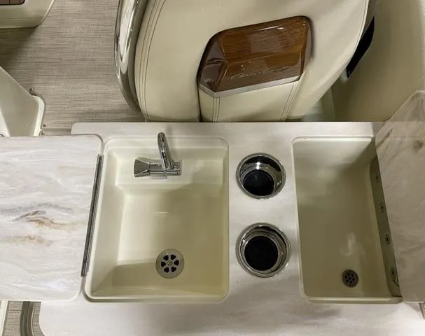 Slide: The Image of 2023 Chris-Craft Calypso 24 boat interior with sink and cup holders. - 33