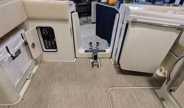 Slide: The Image of 2023 Chris-Craft Calypso 24 boat interior with beige flooring and storage compartments. - 34