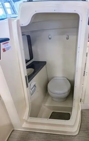 Slide: The Image of 2023 Chris-Craft Calypso 24 boat interior bathroom with toilet and sink. - 36