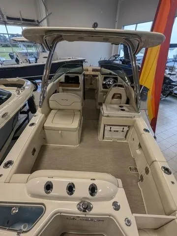 Slide: The Image of 2023 Chris-Craft Calypso 24 boat interior with seating and helm, displayed indoors. - 39