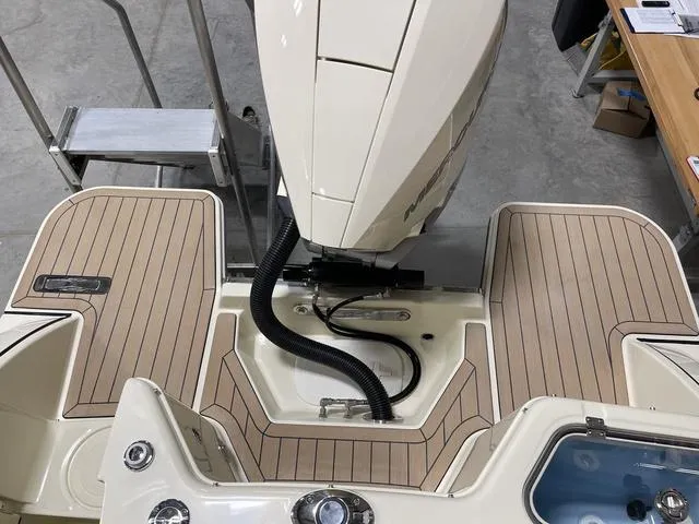 Slide: The Image of 2023 Chris-Craft Calypso 24 boat with outboard motor and teak deck. - 42