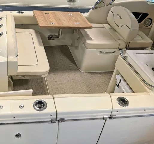 Slide: The Image of 2023 Chris-Craft Calypso 24 boat interior with seating and wooden table. - 5