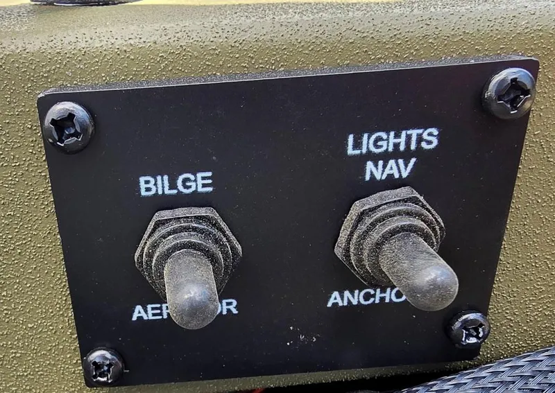 Slide: The Image of Control panel of 2025 Lowe RX1860 RAMBLER with bilge and navigation light switches. - 10