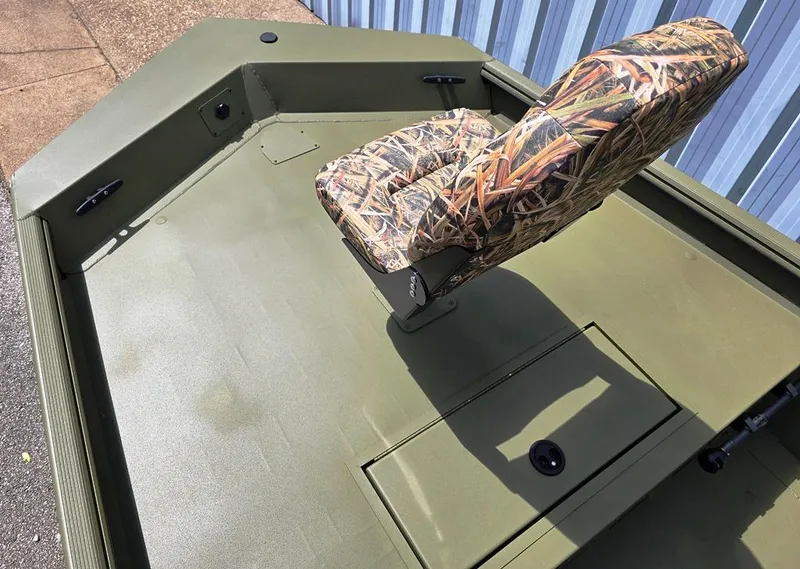 Slide: The Image of 2025 Lowe RX1860 RAMBLER boat with camo seat, green deck, and storage compartment. - 3