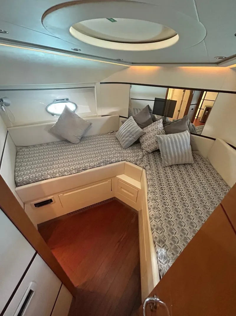 Slide: The Image of Luxurious cabin interior of a 2007 Pershing 62' yacht with elegant bedding and ambient lighting. - 12