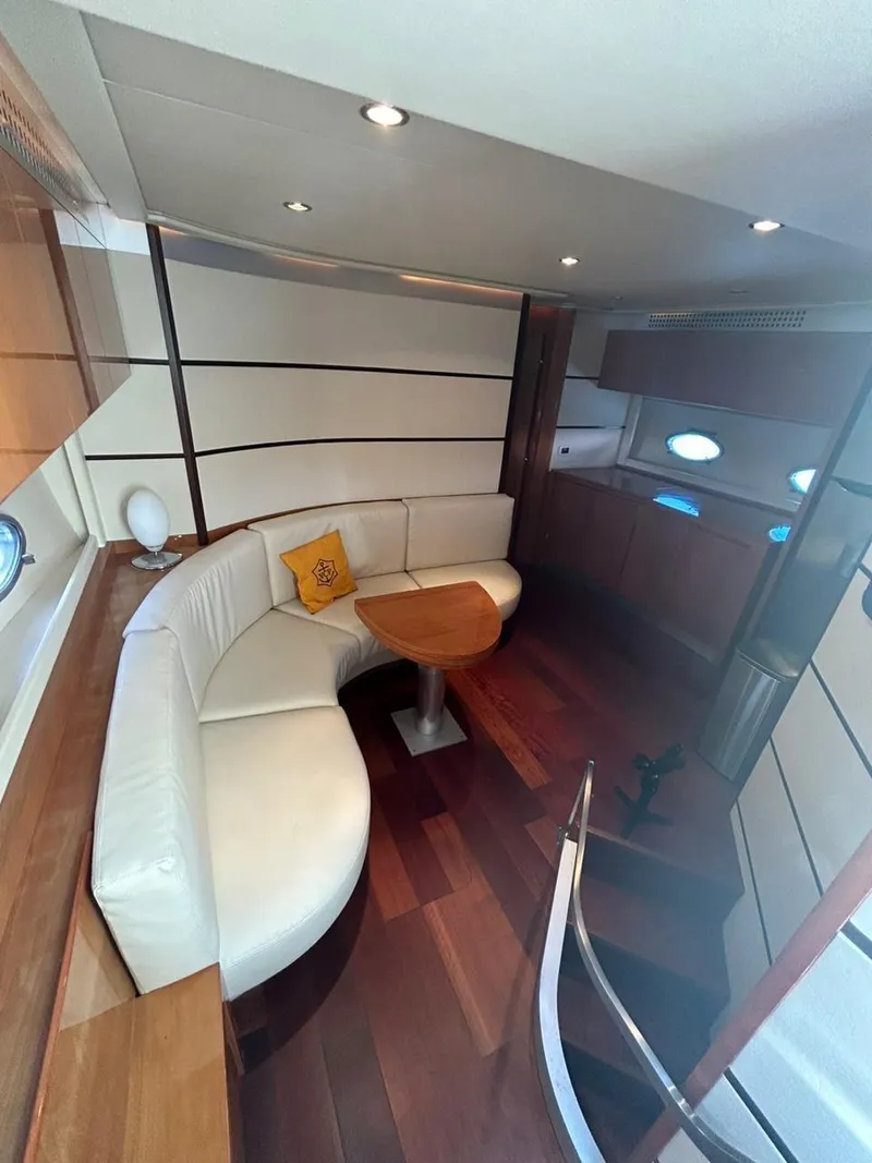 Slide: The Image of Luxurious interior of a 2007 Pershing 62' yacht with elegant seating and wooden accents. - 13