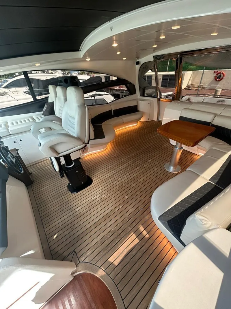Slide: The Image of Luxurious 2007 Pershing 62' yacht interior with elegant seating and wooden flooring. - 15