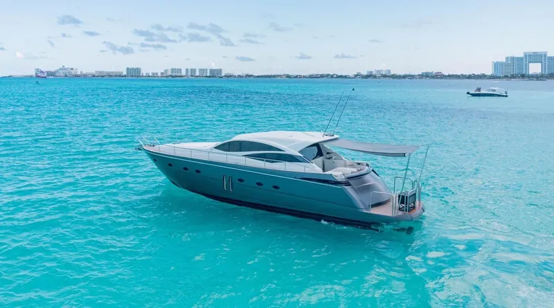 Slide: The Image of 2007 Pershing 62' yacht on turquoise waters, clear sky, distant cityscape. - 7