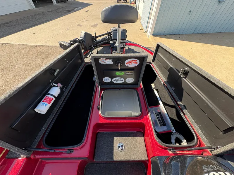 Slide: The Image of 2007 Triton Tr-186 SC boat interior with storage compartments and fire extinguisher. - 11