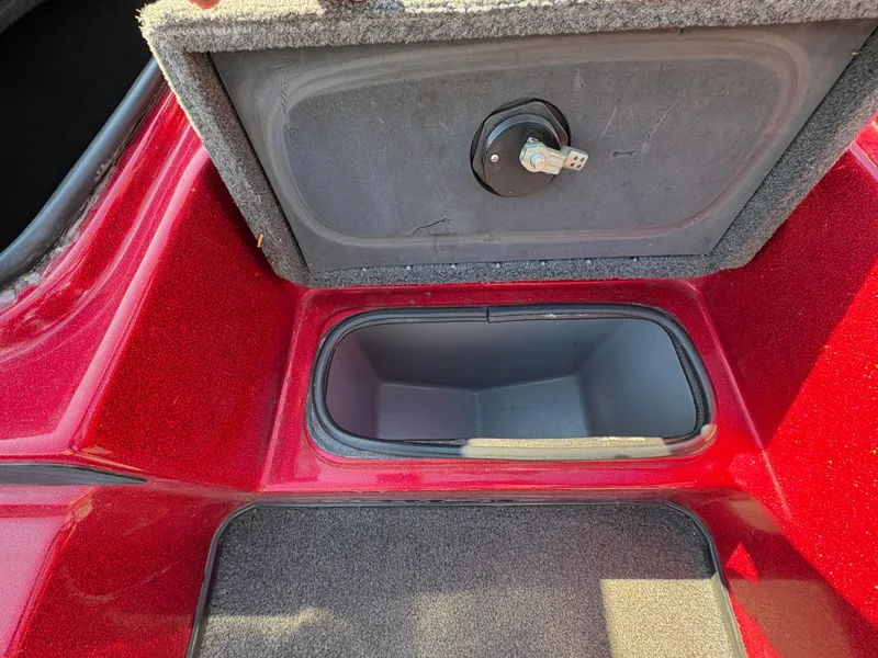 Slide: The Image of 2007 Triton Tr-186 SC boat storage compartment with red and gray interior. - 13