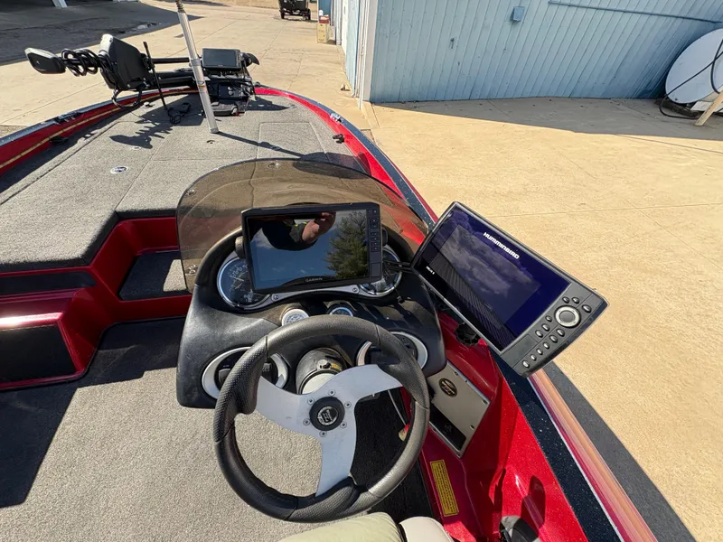 Slide: The Image of 2007 Triton Tr-186 SC boat dashboard with steering wheel and electronic displays. - 17