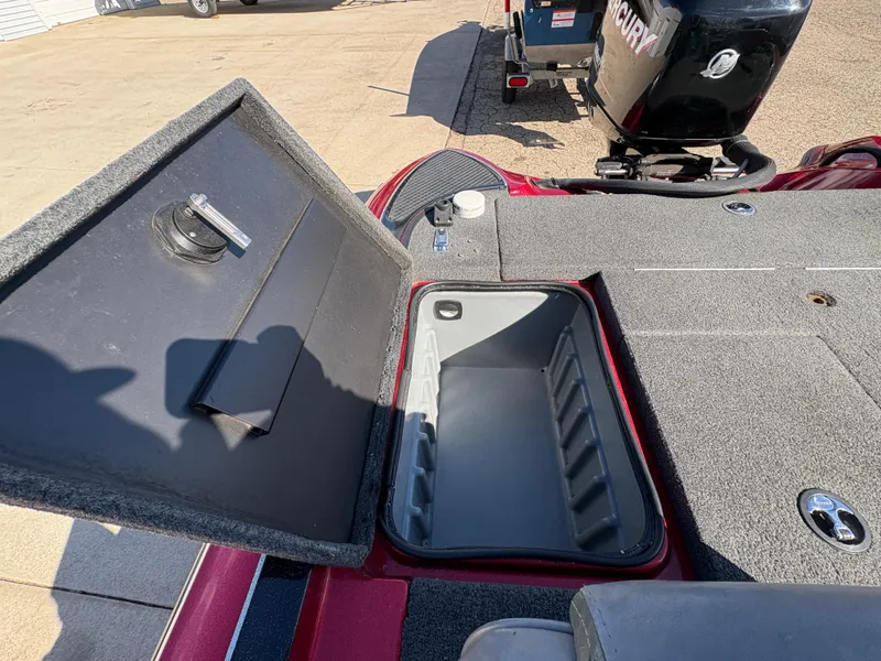 Slide: The Image of Open storage compartment on a 2007 Triton Tr-186 SC boat, with visible engine in background. - 21