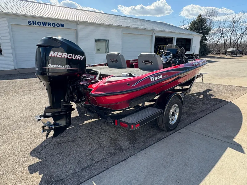 Slide: The Image of 2007 Triton Tr-186 SC boat with Mercury engine parked outside a showroom. - 5