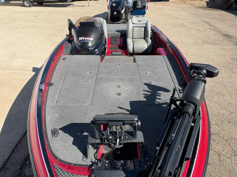Slide: The Image of 2007 Triton Tr-186 SC fishing boat with red exterior and spacious deck layout. - 9