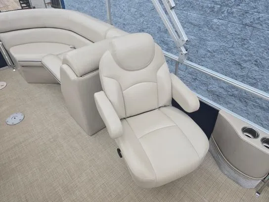 Slide: The Image of 2018 South Bay 222RS boat interior with beige seating and cup holders. - 6