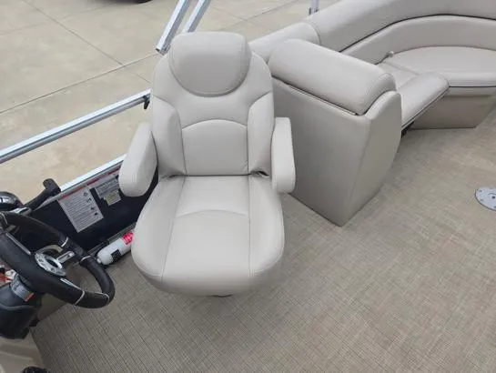 Slide: The Image of 2018 South Bay 222RS boat interior with beige captain's chair and seating. - 7