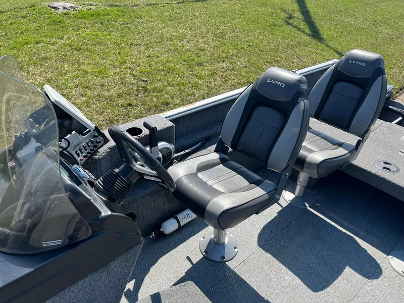 Slide: The Image of 2017 Lund 1750 Rebel XS SS boat interior with two seats and steering console. - 13