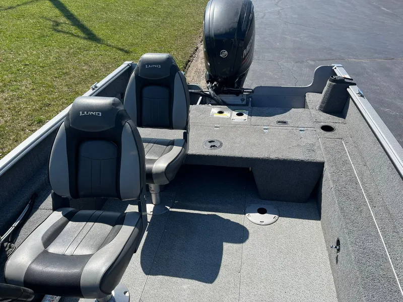 Slide: The Image of 2017 Lund 1750 Rebel XS SS boat interior with two seats and motor. - 14