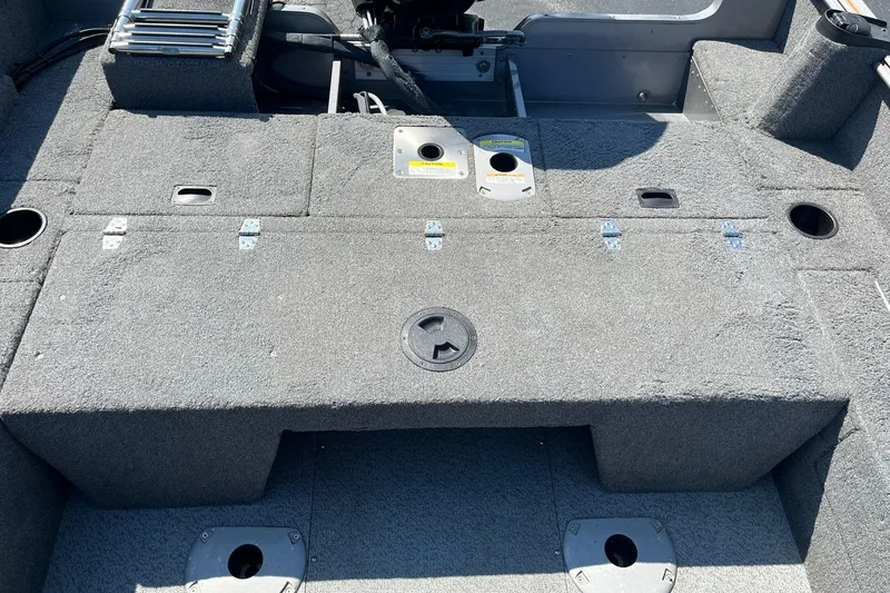 Slide: The Image of 2017 Lund 1750 Rebel XS SS boat interior with storage compartments and carpeted deck. - 17