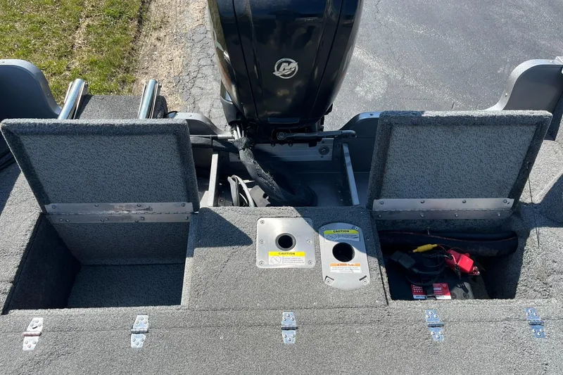 Slide: The Image of 2017 Lund 1750 Rebel XS SS boat interior with storage compartments and motor. - 19