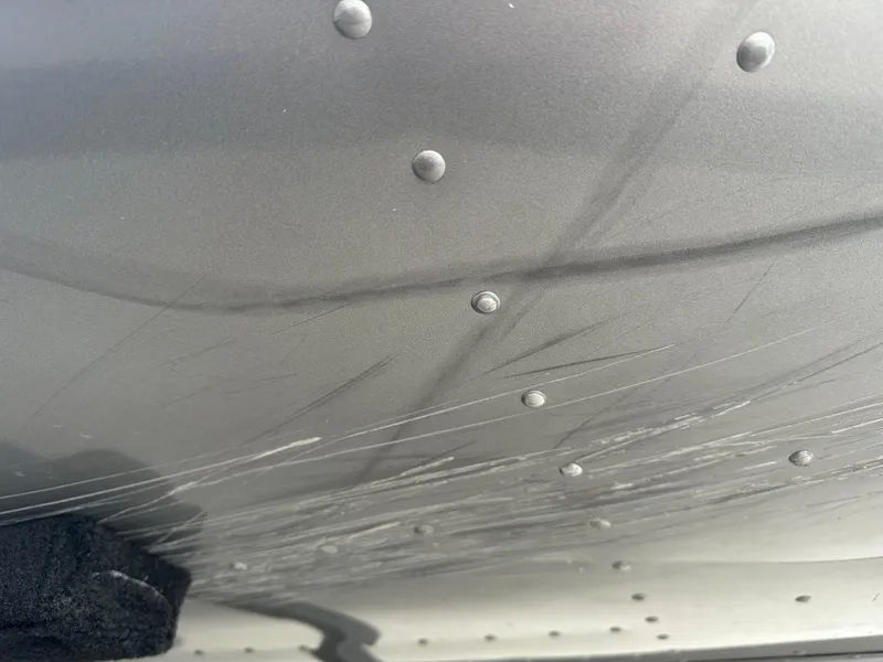 Slide: The Image of Close-up of 2017 Lund 1750 Rebel XS SS boat hull with visible scratches. - 31