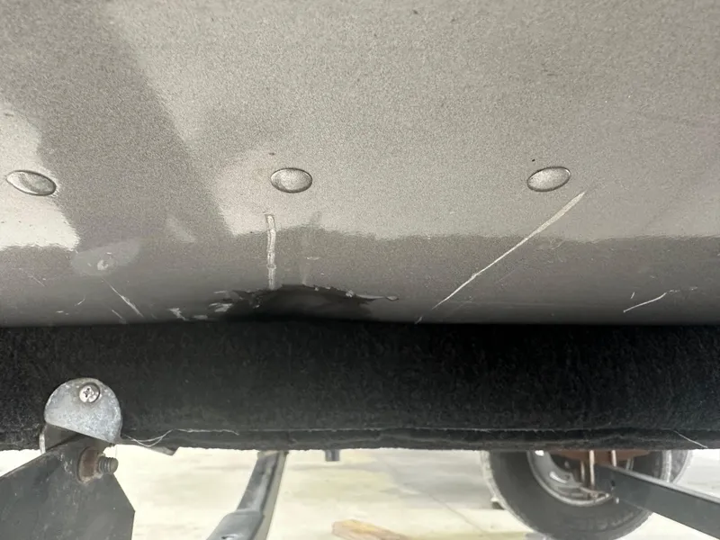 Slide: The Image of 2017 Lund 1750 Rebel XS SS boat hull with visible scratches and damage. - 32