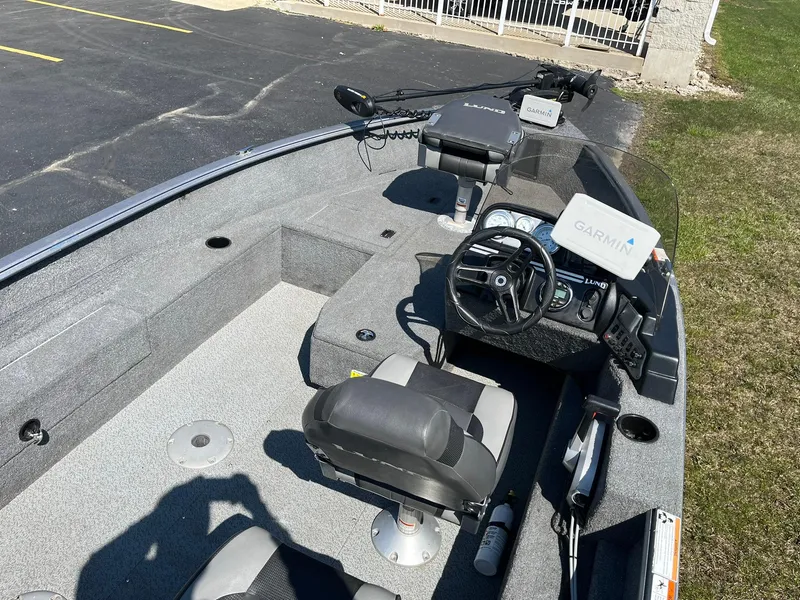 Slide: The Image of 2017 Lund 1750 Rebel XS SS boat interior with steering wheel and Garmin device. - 7